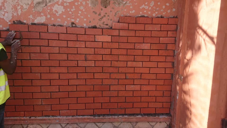 Fresh red brick wall prepared for exterior finishing