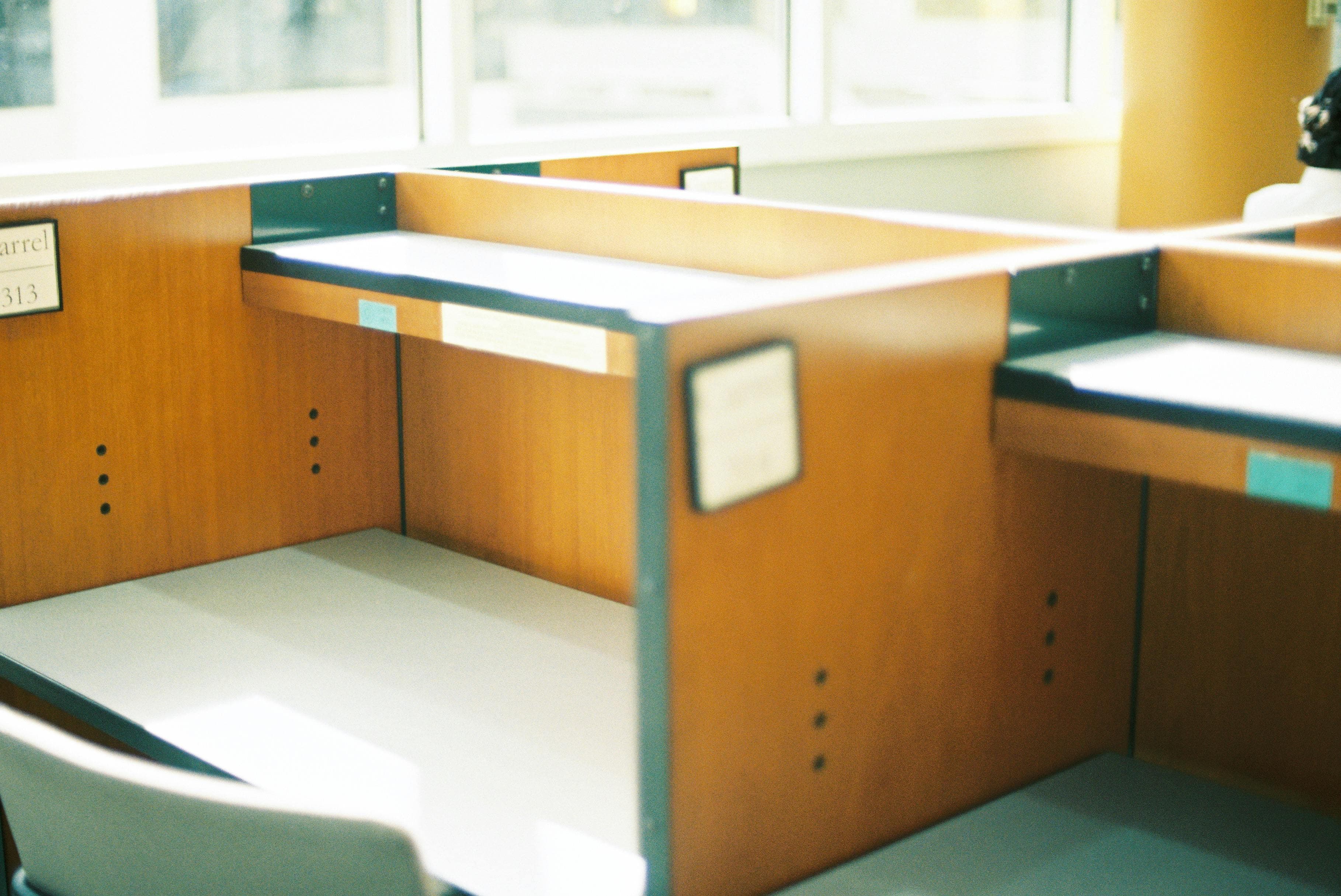 Office desk partitioning reference with warm workstation finishes